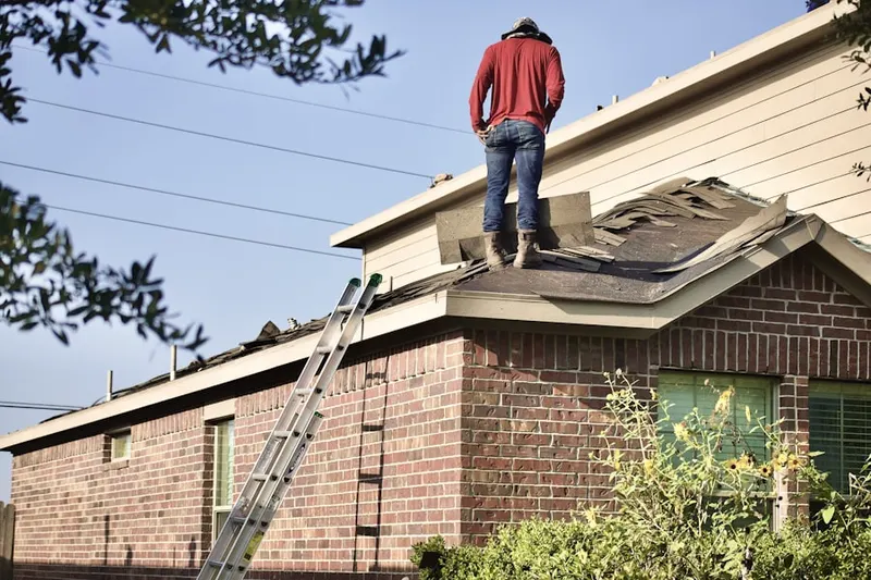 Professional roofer working on a residential roof in Harris Landing